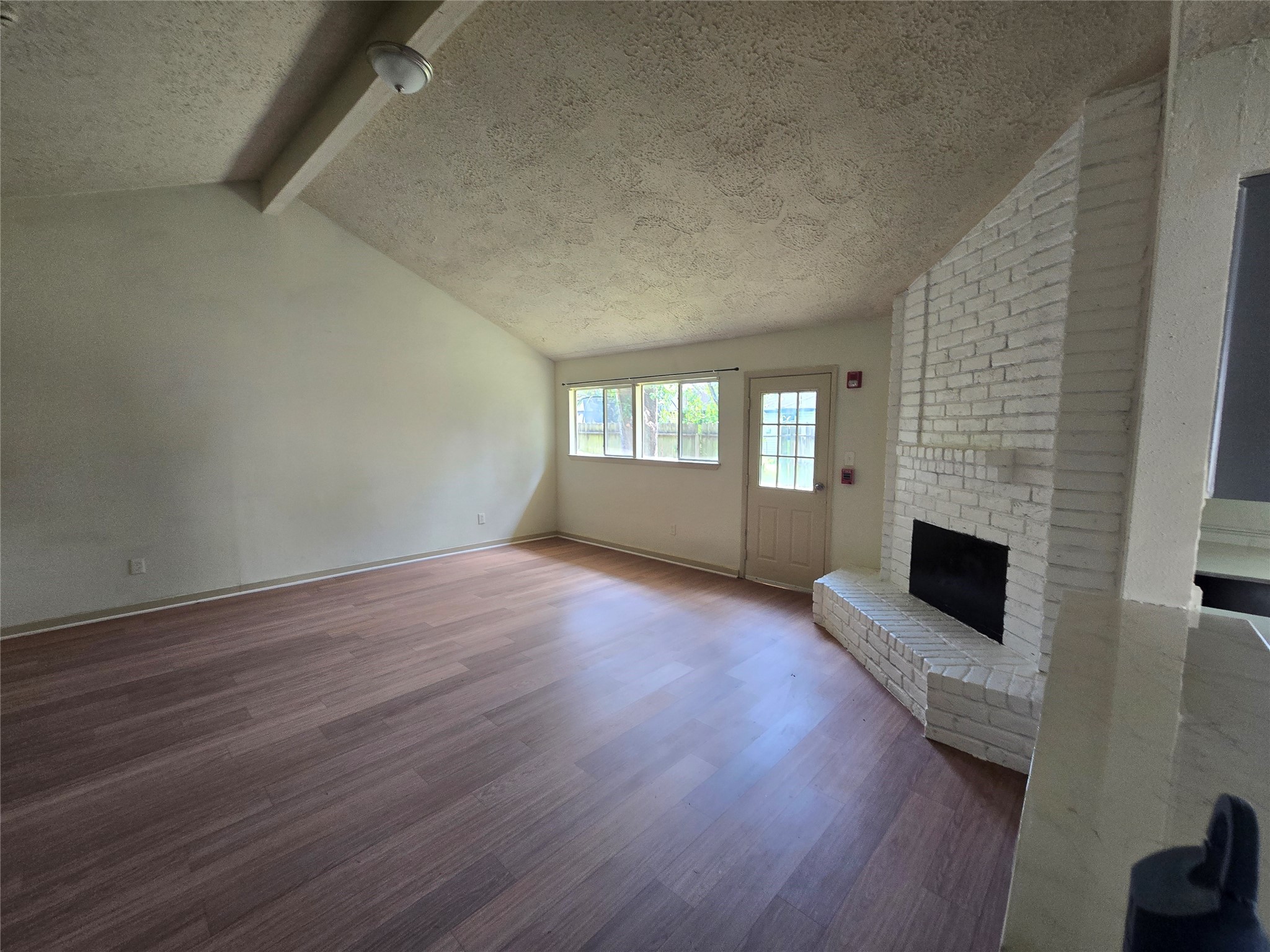 16331 Dew Drop Lane Houston, TX 77095 - Photo 6 of 20 a view of empty room with fireplace and wooden floor