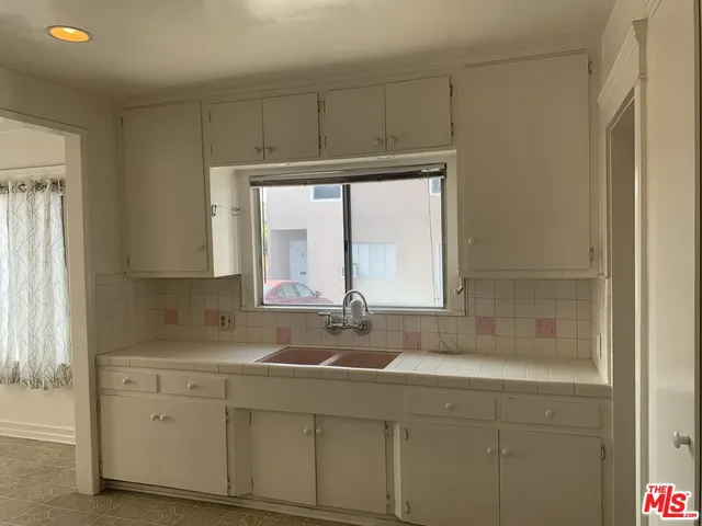 a bathroom with a sink and a window