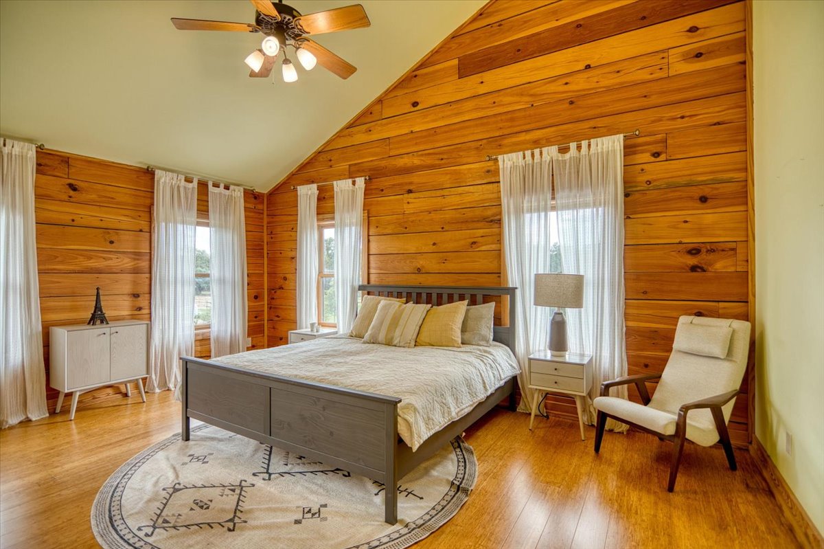 301 Blessing Ranch Road Liberty Hill, TX 78642 - Photo 22 of 40 a bedroom with a bed and wooden floor