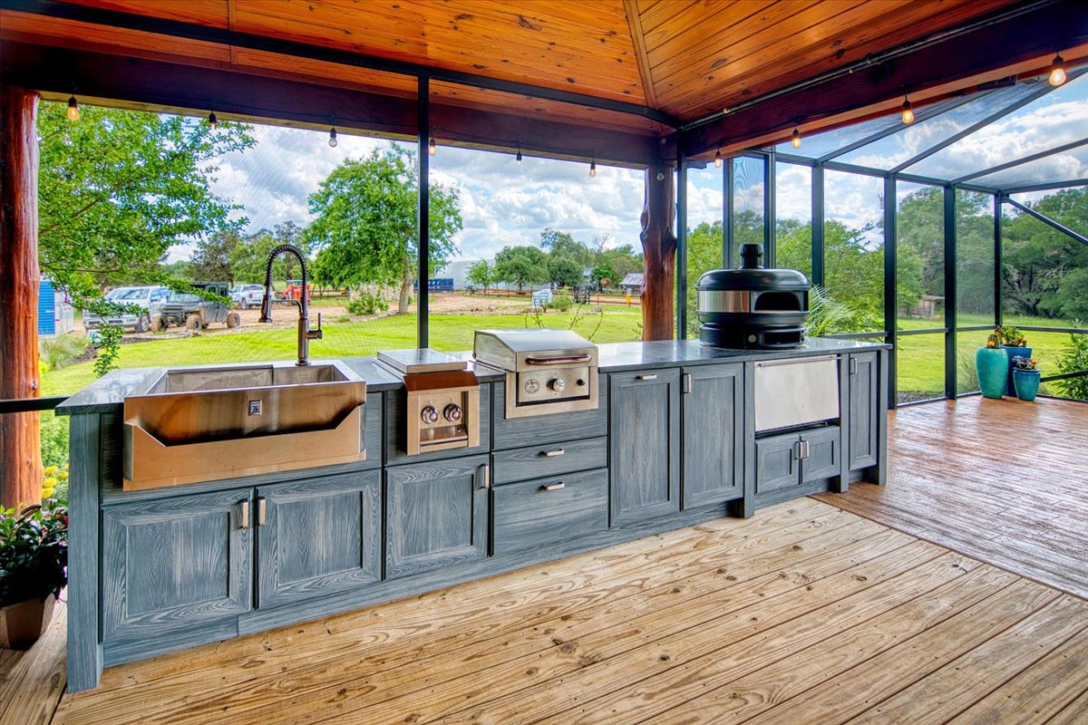 301 Blessing Ranch Road Liberty Hill, TX 78642 - Photo 25 of 40 a kitchen with stainless steel appliances granite countertop a stove and a wooden floor