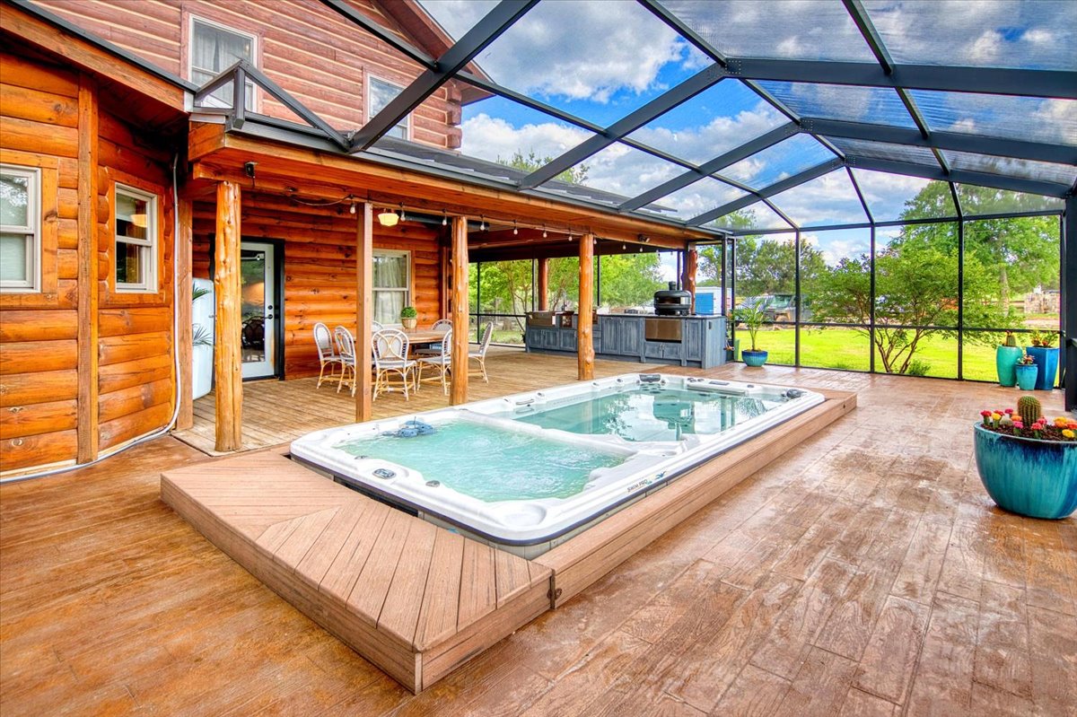 301 Blessing Ranch Road Liberty Hill, TX 78642 - Photo 26 of 40 a view of a patio with a table and chairs under an umbrella