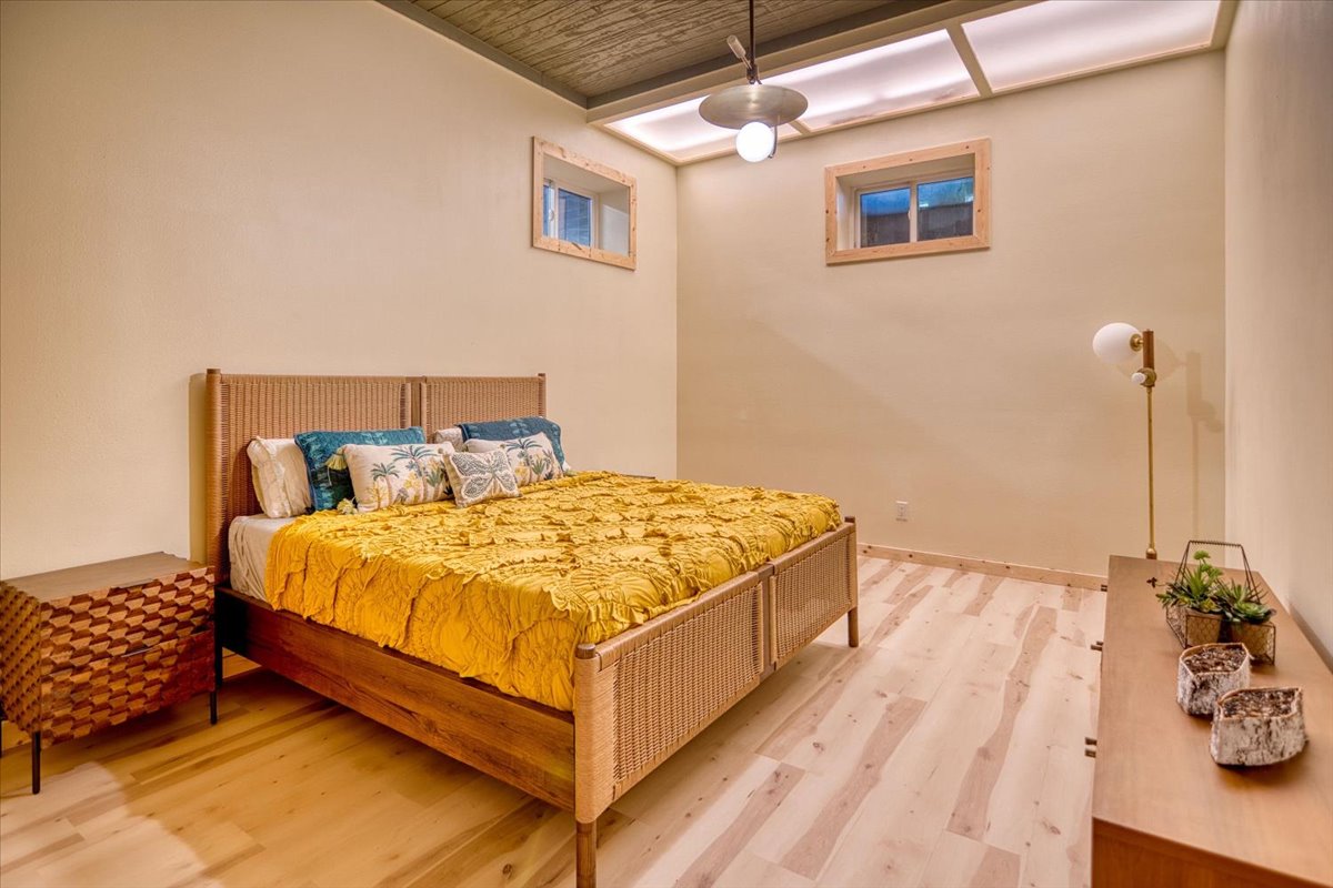 301 Blessing Ranch Road Liberty Hill, TX 78642 - Photo 30 of 40 a bed sitting in a bedroom next to a window and a wooden floor