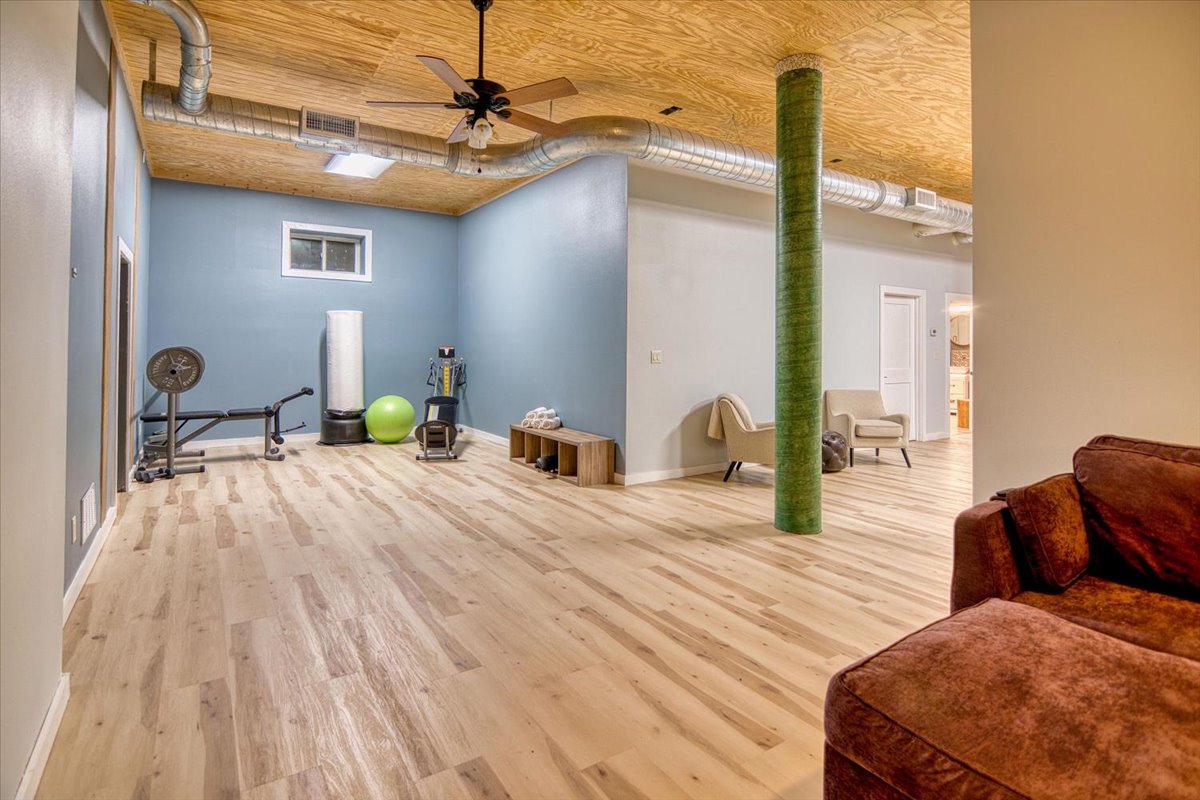 301 Blessing Ranch Road Liberty Hill, TX 78642 - Photo 37 of 40 a bedroom with a bed and wooden floor