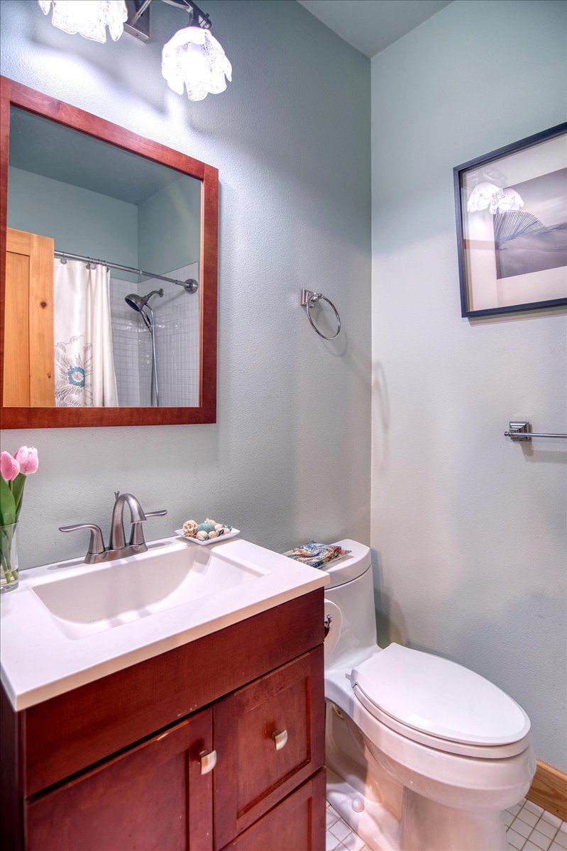 301 Blessing Ranch Road Liberty Hill, TX 78642 - Photo 8 of 40 a bathroom with a toilet a sink and mirror