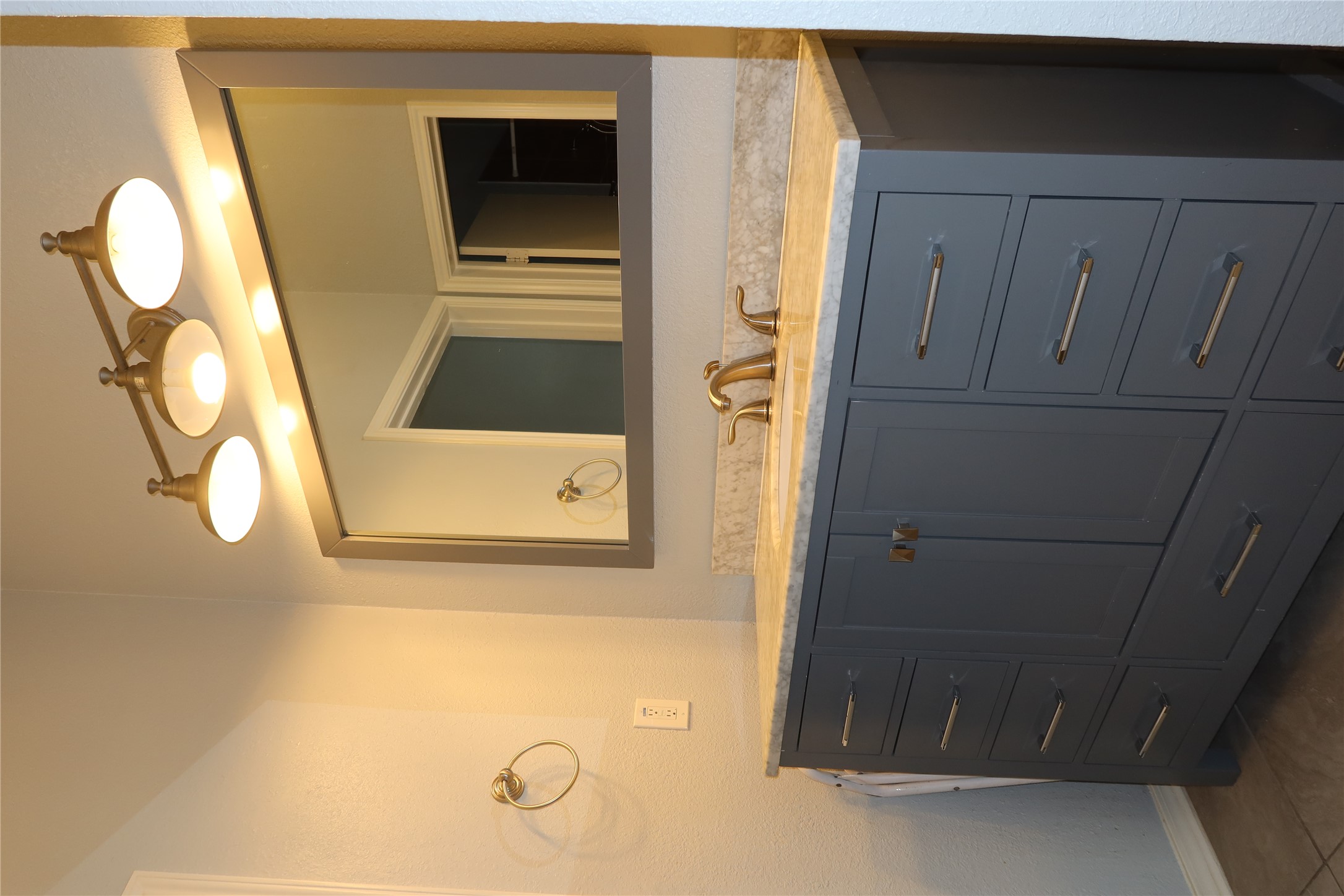 2802 Nueces Street, Unit 306 Austin, TX 78705 - Photo 9 of 20 Spacious vanity featuring a light-toned countertop, undermount sink, and a dual-door cabinet