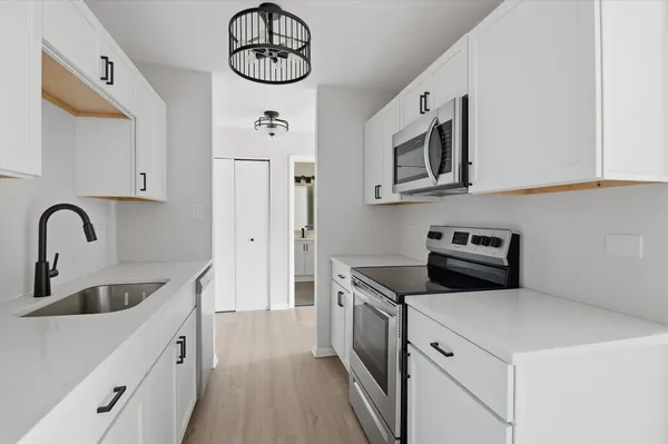 a kitchen with a sink and cabinets