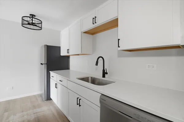 a kitchen with stainless steel appliances granite countertop a sink stove and microwave