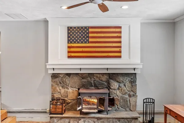 a living room with a fireplace and a rug