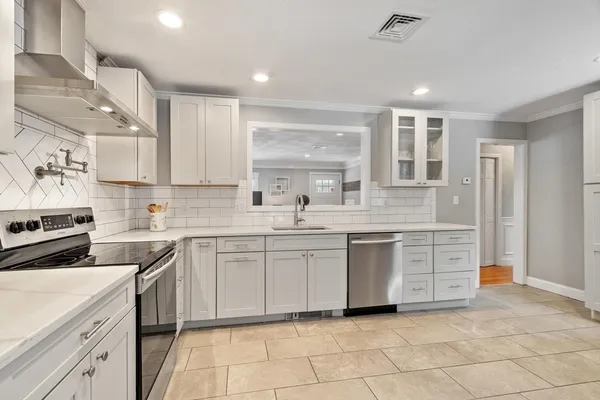 a kitchen with a sink stove and cabinets