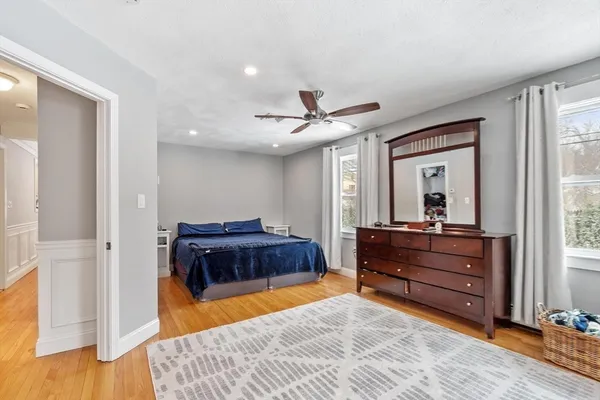 a living room with a bed and a chandelier