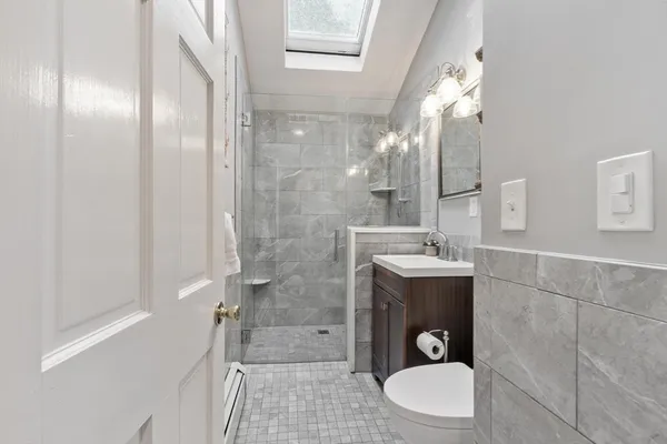 a bathroom with a sink toilet and shower