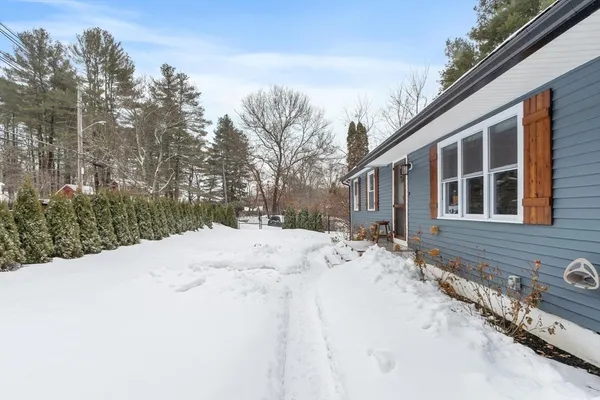 a pathway of a house with a yard covered in snow