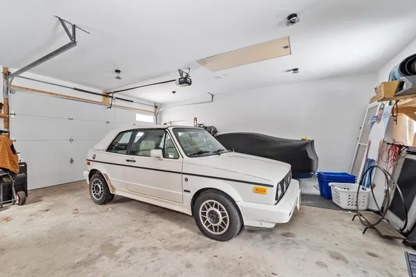 a car and bike parked in a garage
