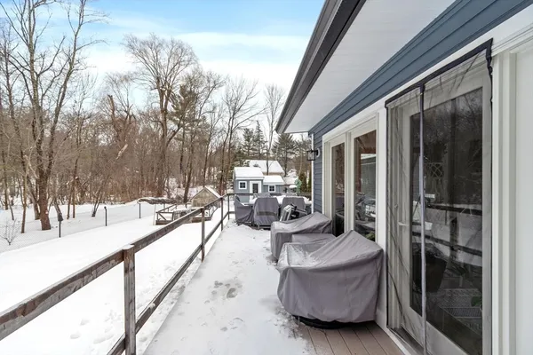a white house with a large tree in front of it