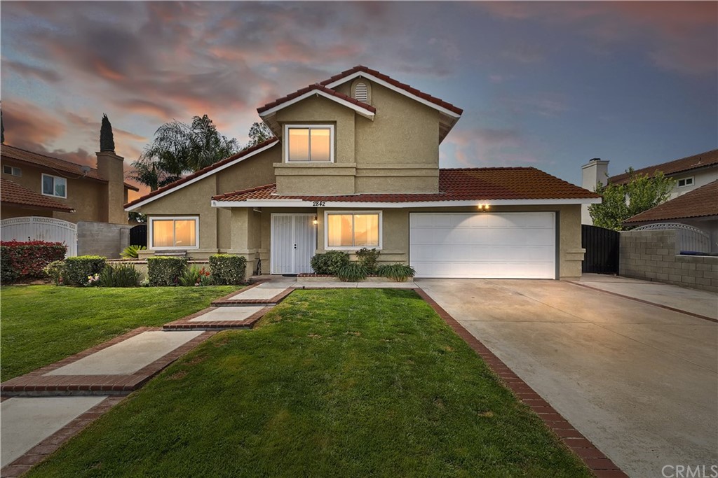 a front view of a house with a yard and garage