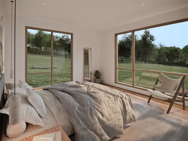 a bed sitting in a bedroom next to a window