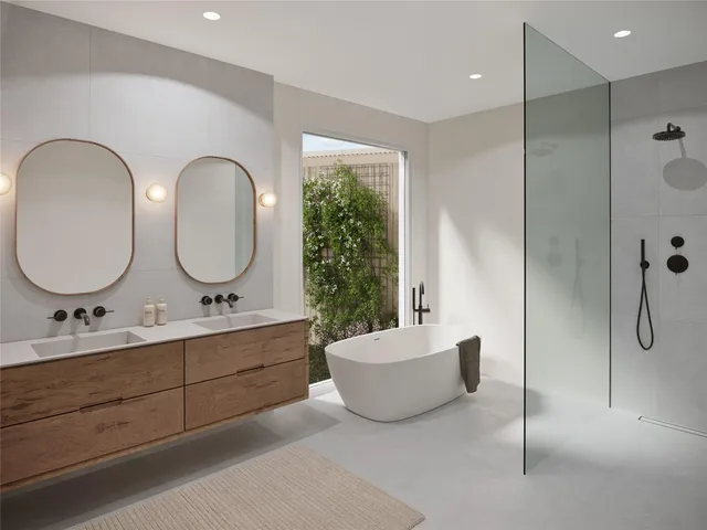 a bathroom with a double vanity sink a mirror and a shower