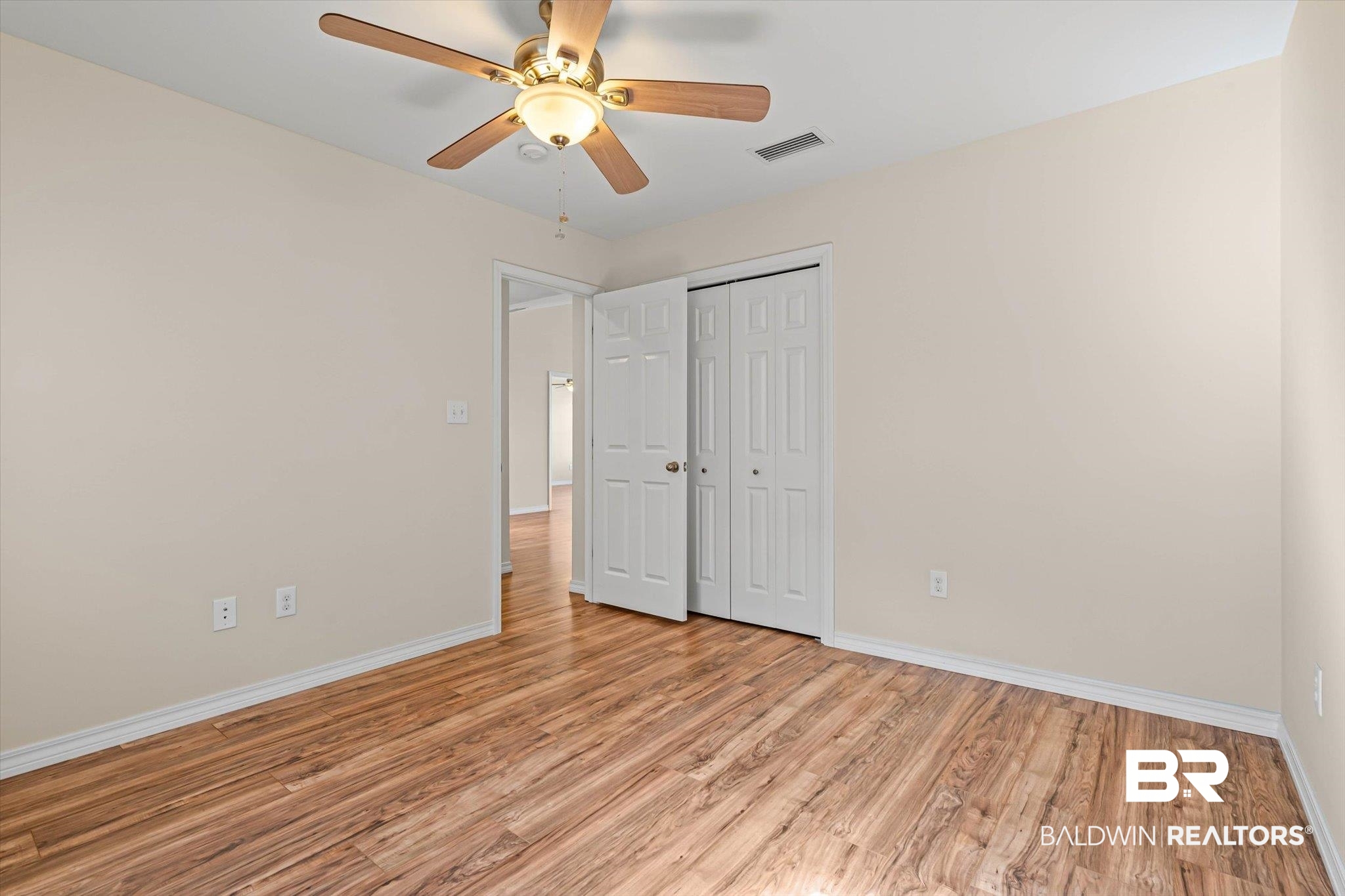 919 Sailor Circle Foley, AL 36535 - Photo 19 of 24 Unfurnished bedroom featuring a ceiling fan, light wood-style floors, and a closet