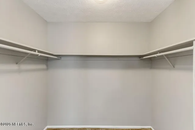 a view of a room with shelf on the wall