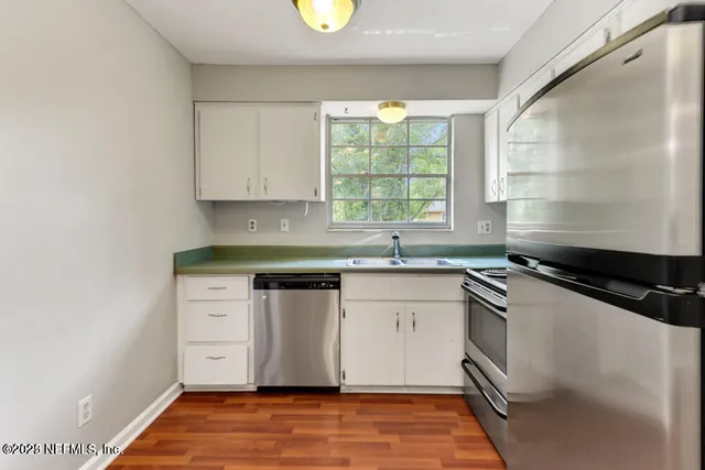 a kitchen with granite countertop a sink and a stove