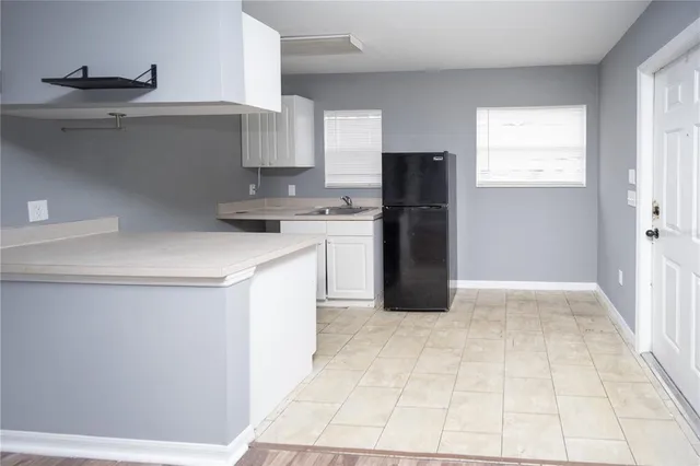 a kitchen with a refrigerator and a sink