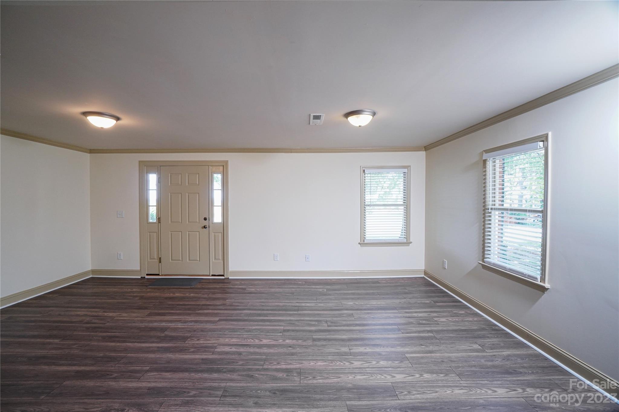 1302 Trinity Church Road Monroe, NC 28112 - Photo 8 of 37 a view of an empty room with wooden floor and windows