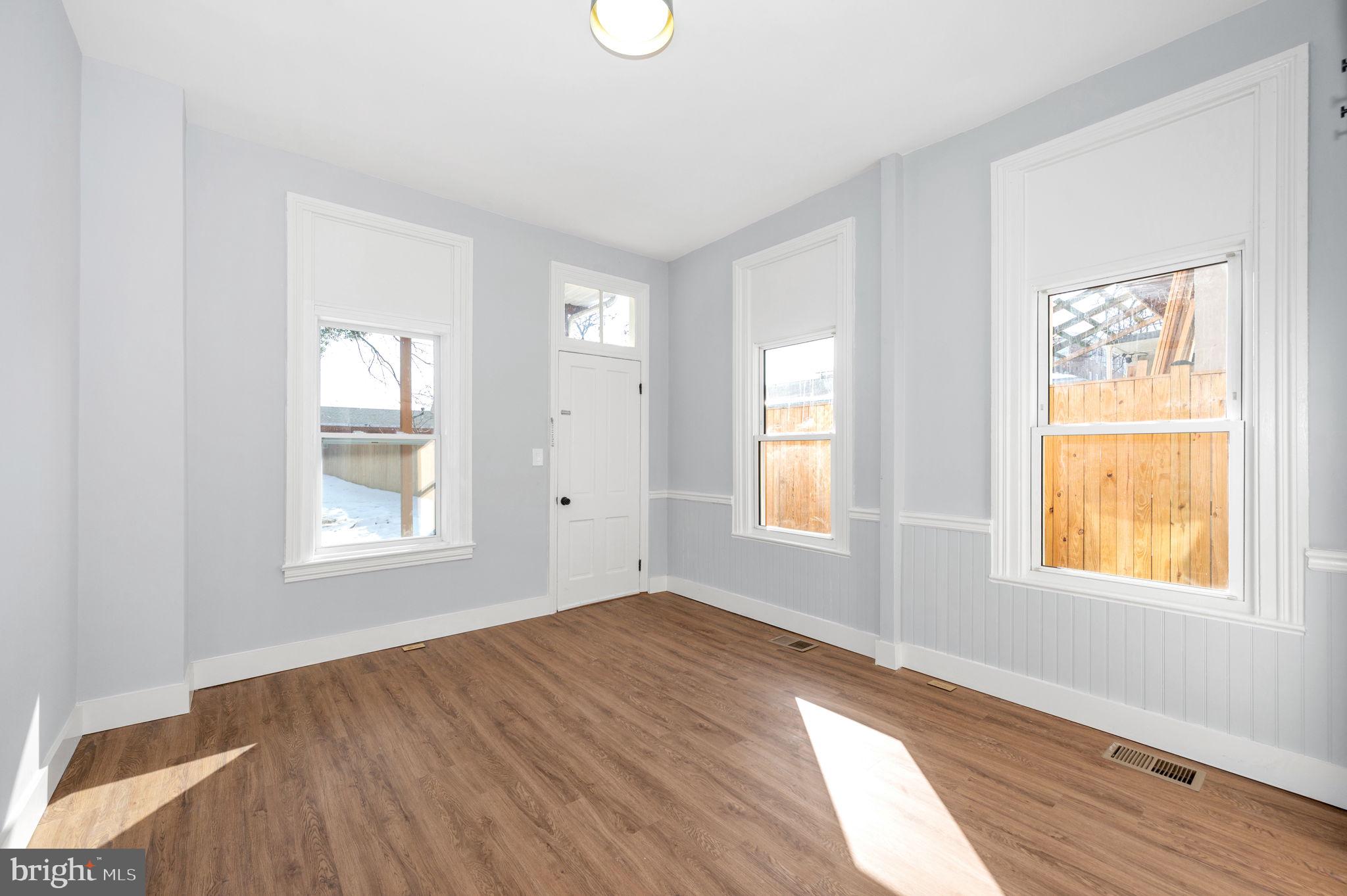 230 South Market Street, Unit 1 Frederick, MD 21701 - Photo 12 of 27 an empty room with wooden floor and windows