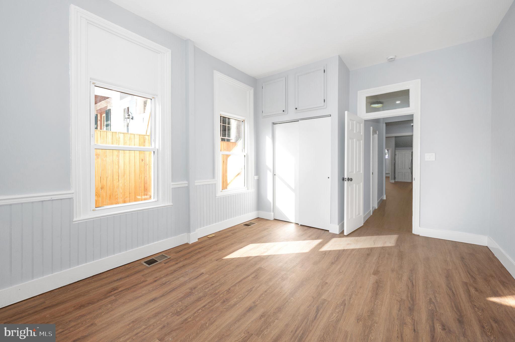 230 South Market Street, Unit 1 Frederick, MD 21701 - Photo 13 of 27 a view of an empty room with wooden floor and a window