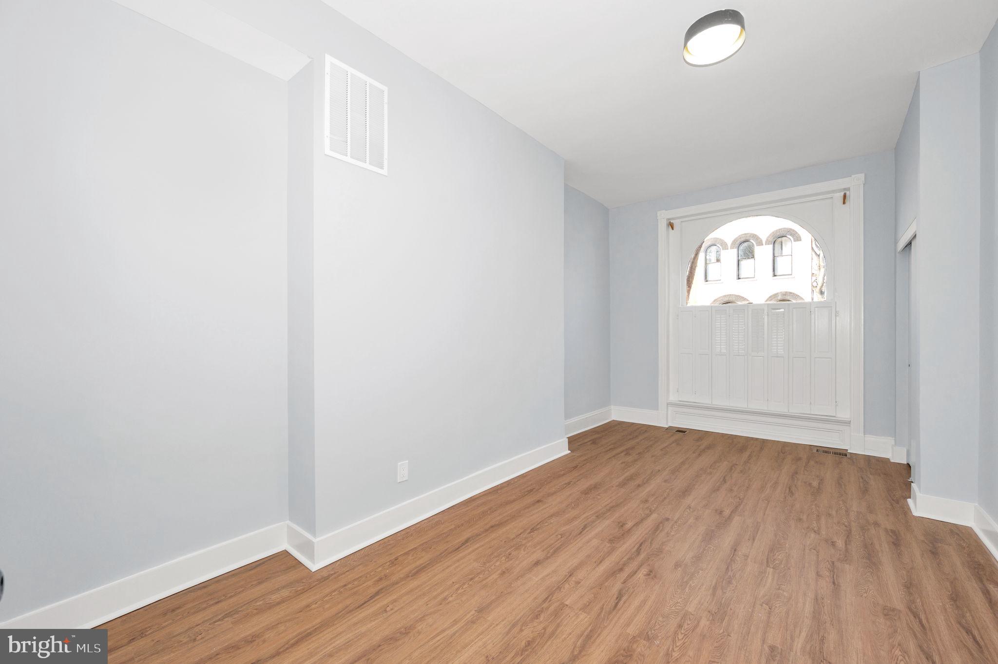230 South Market Street, Unit 1 Frederick, MD 21701 - Photo 14 of 27 an empty room with wooden floor and windows