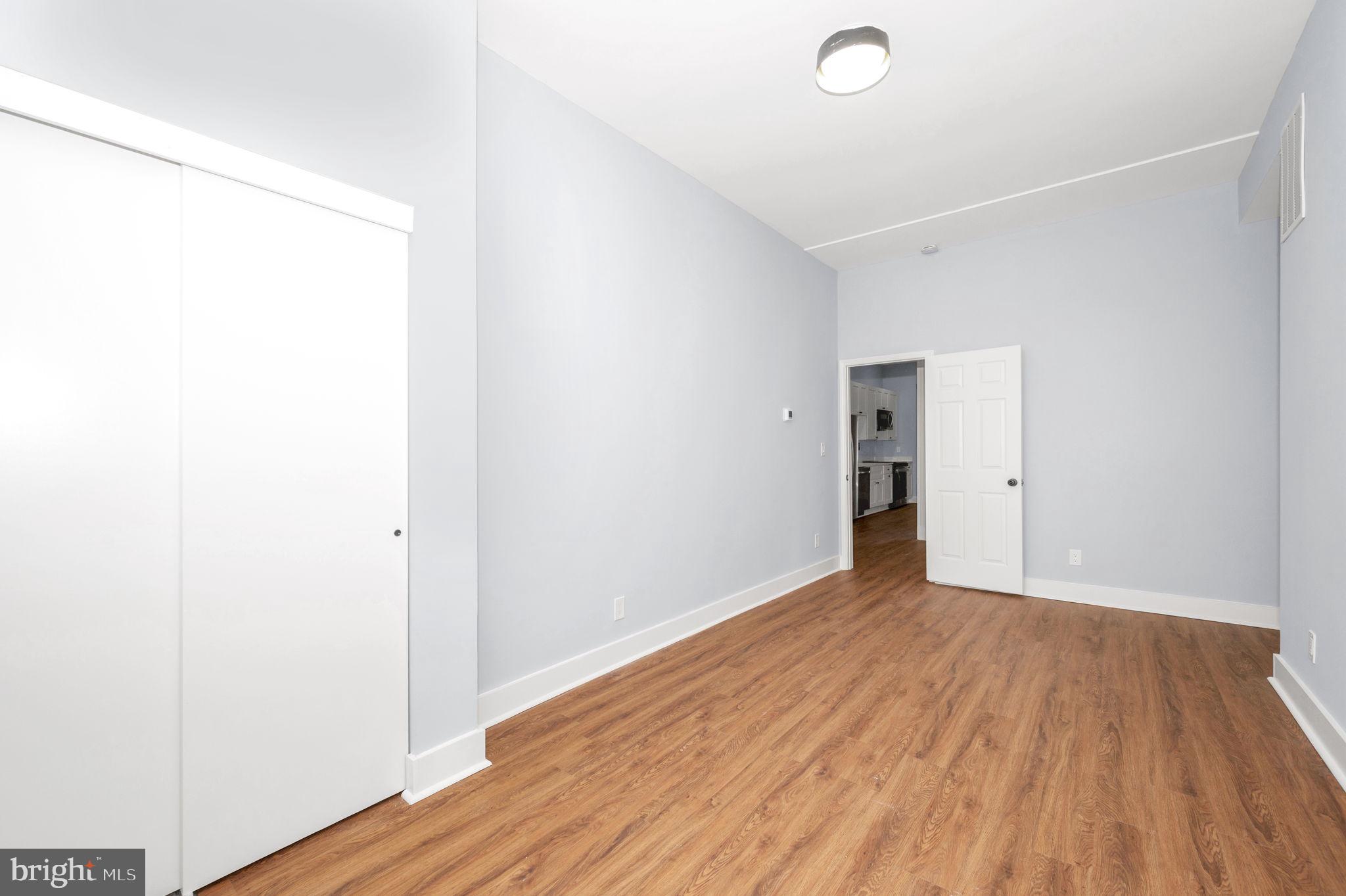230 South Market Street, Unit 1 Frederick, MD 21701 - Photo 15 of 27 a view of an empty room with wooden floor