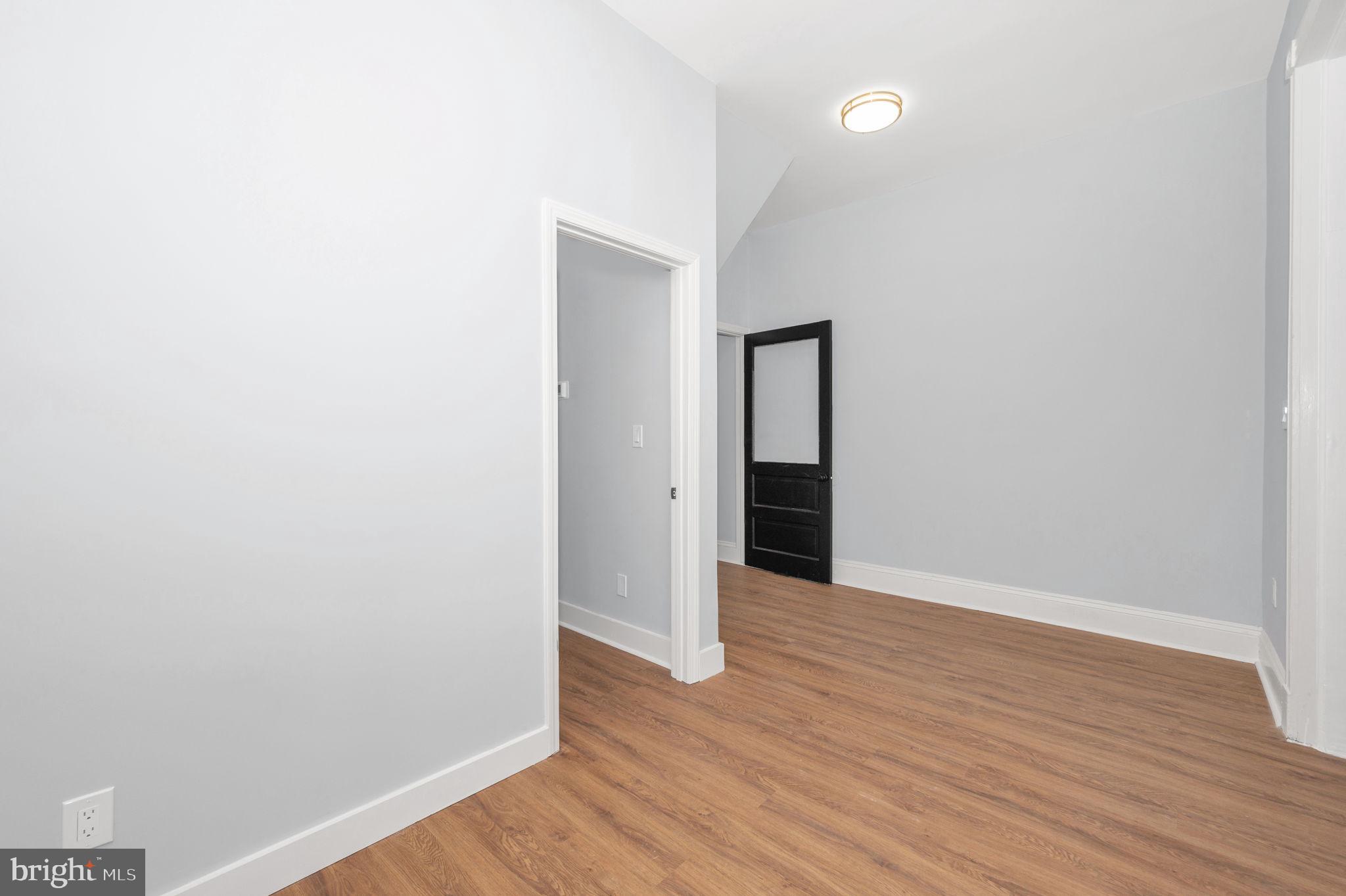 230 South Market Street, Unit 1 Frederick, MD 21701 - Photo 4 of 27 a view of an empty room with wooden floor