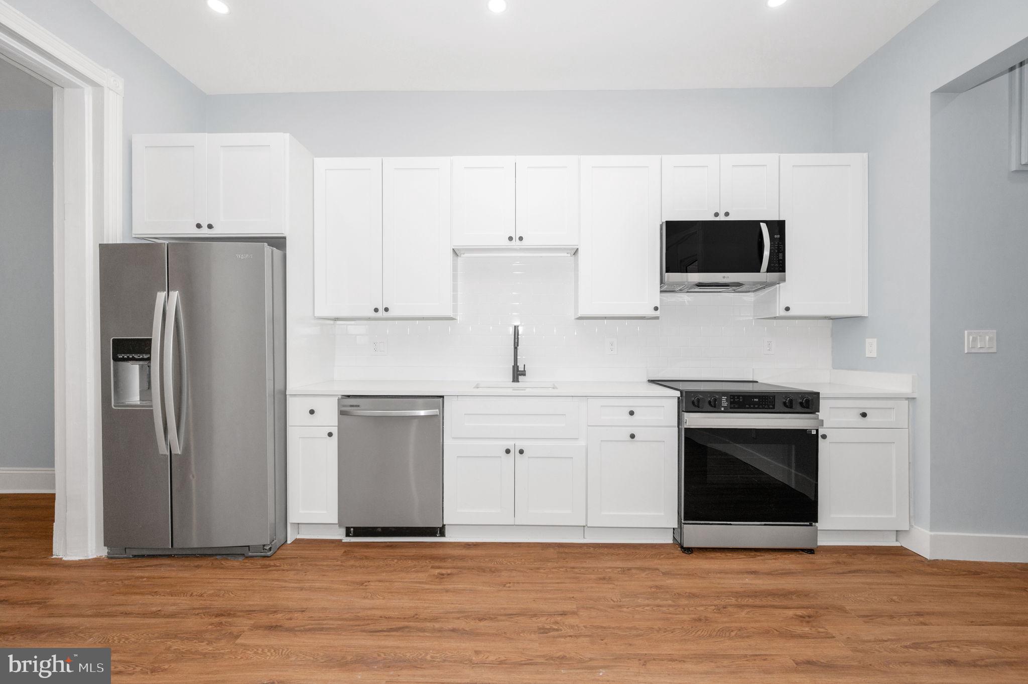 230 South Market Street, Unit 1 Frederick, MD 21701 - Photo 6 of 27 a kitchen with a stove and a microwave