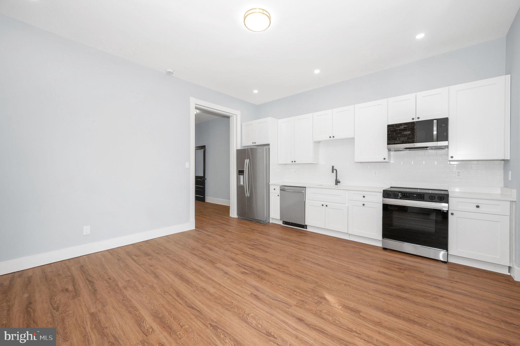230 South Market Street, Unit 1 Frederick, MD 21701 - Photo 8 of 27 a kitchen with stainless steel appliances granite countertop a stove a sink and a refrigerator