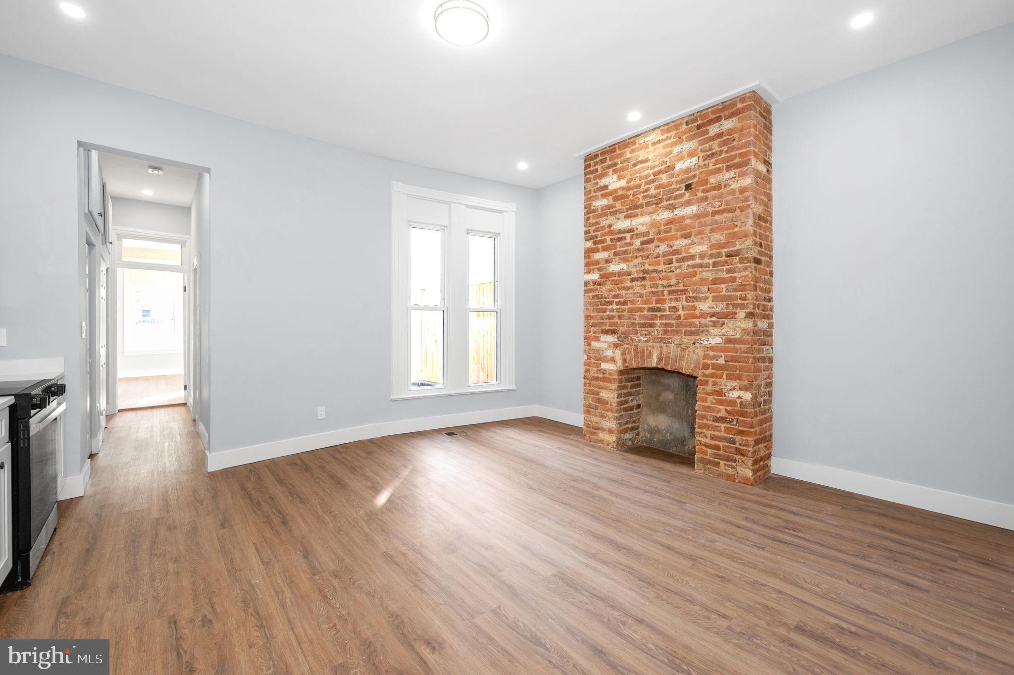 230 South Market Street, Unit 1 Frederick, MD 21701 - Photo 9 of 27 an empty room with wooden floor and windows