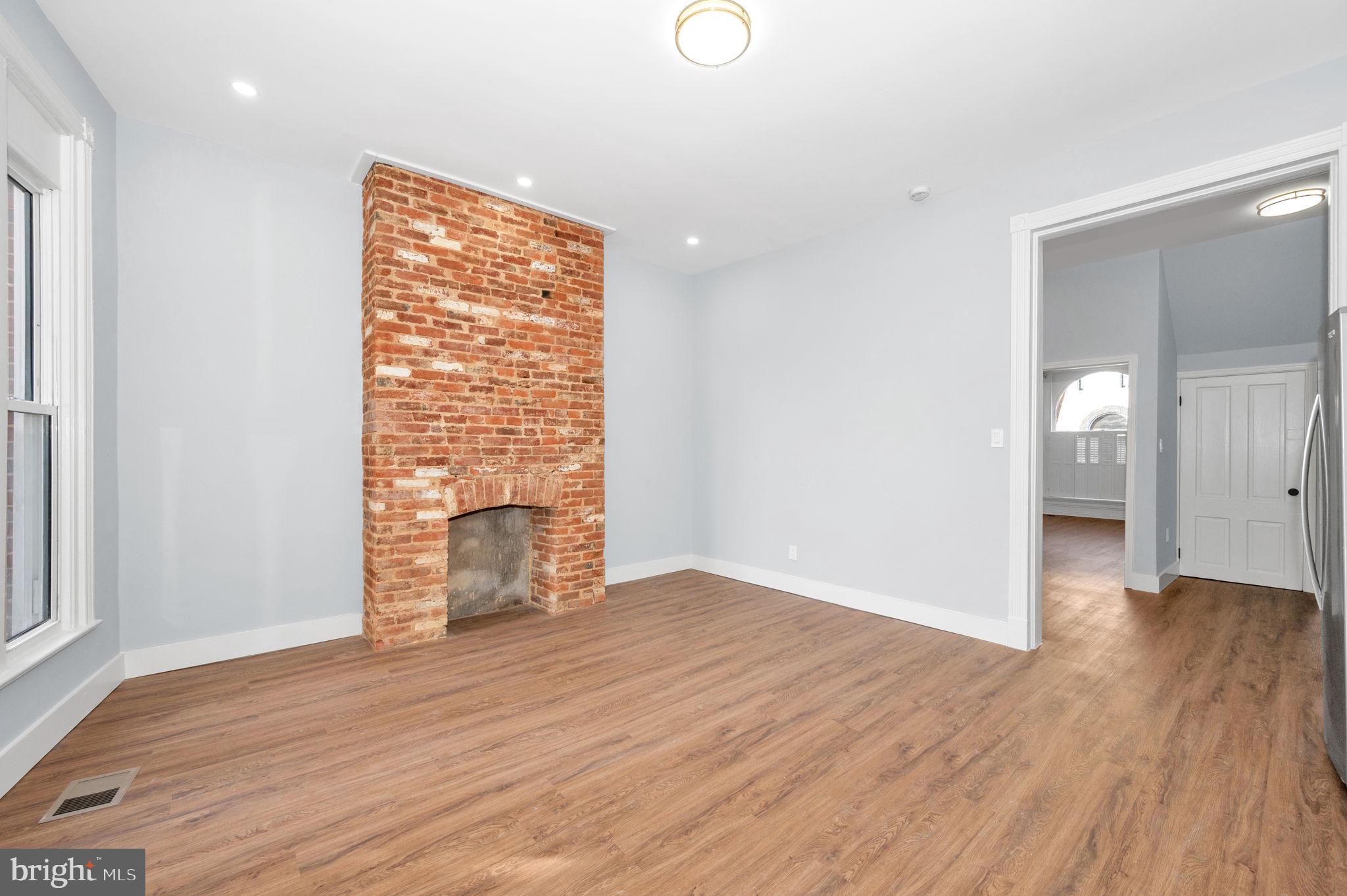 230 South Market Street, Unit 1 Frederick, MD 21701 - Photo 10 of 27 a view of an empty room with wooden floor and a window