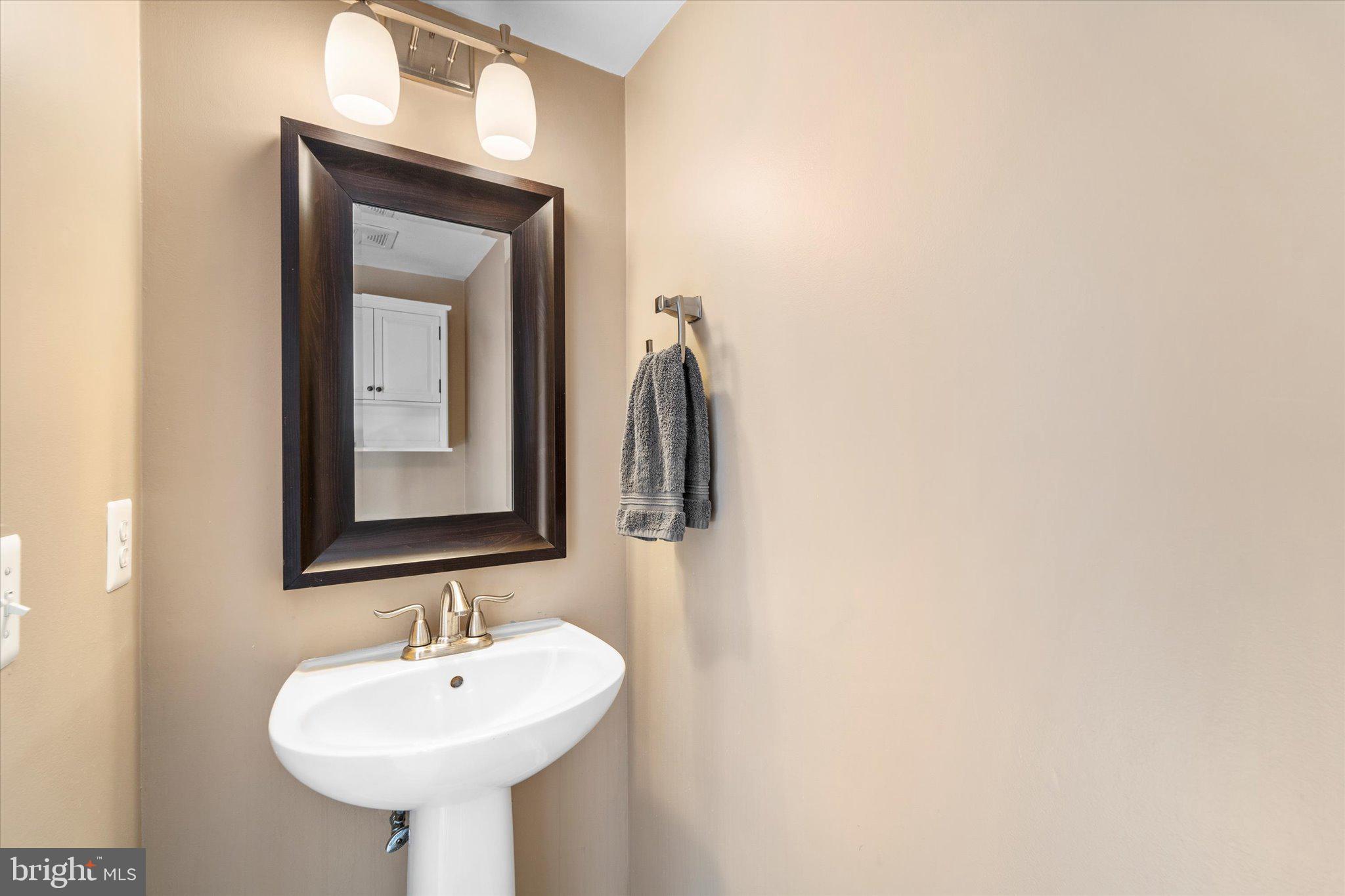 21070 Tyler Too Terrace Ashburn, VA 20147 - Photo 11 of 66 a bathroom with a sink and a mirror