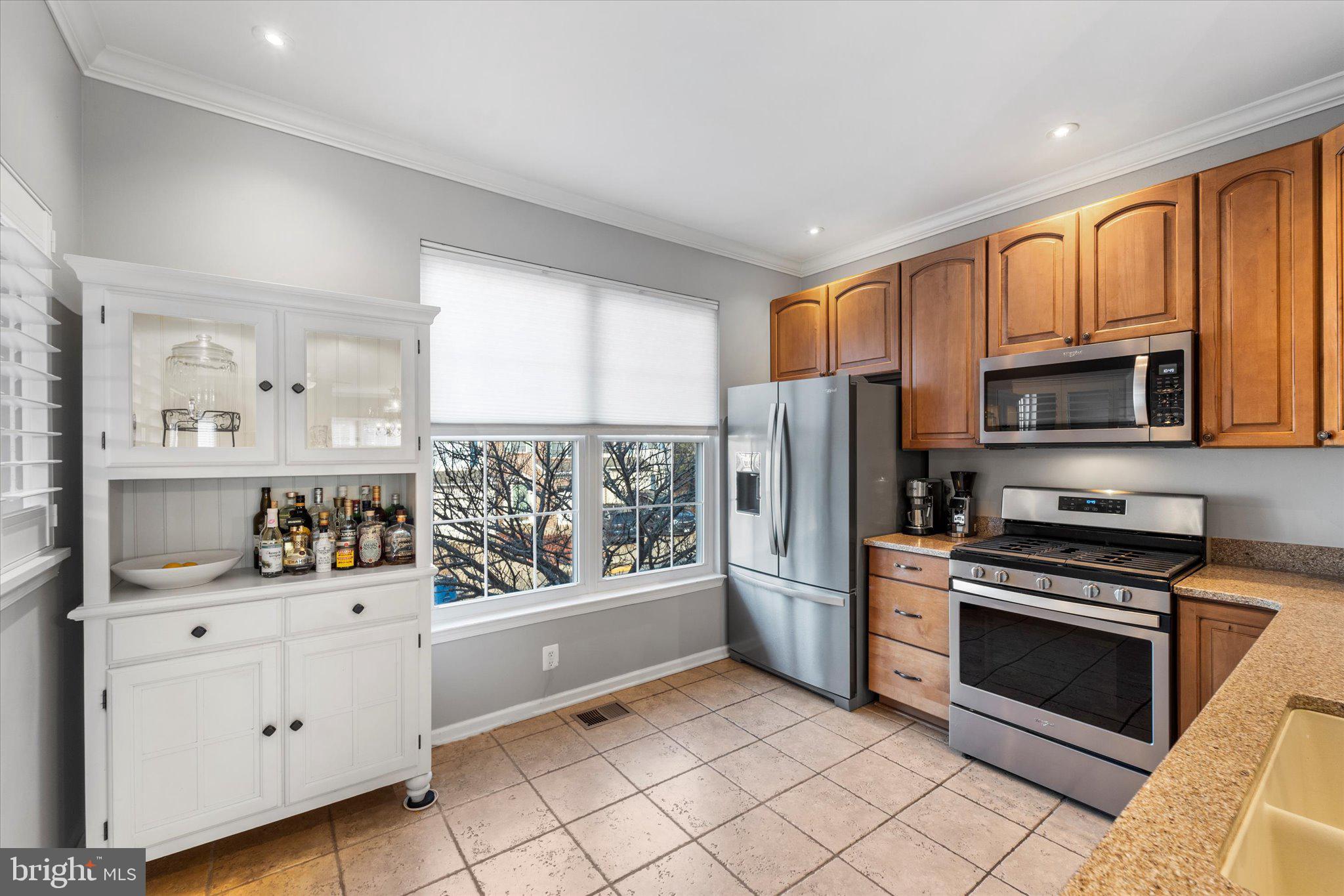 21070 Tyler Too Terrace Ashburn, VA 20147 - Photo 12 of 66 a kitchen with stainless steel appliances a refrigerator stove and microwave