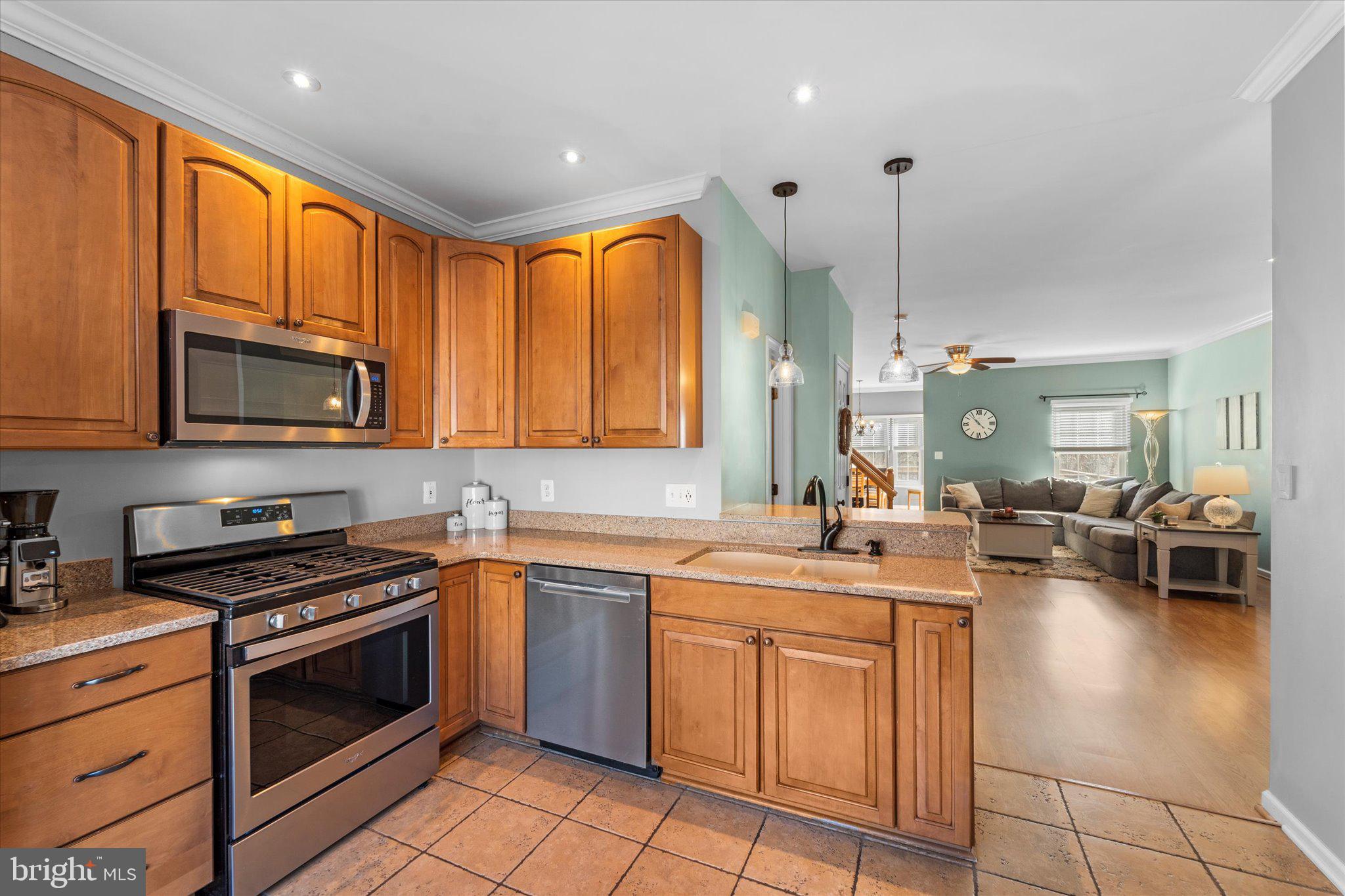 21070 Tyler Too Terrace Ashburn, VA 20147 - Photo 14 of 66 a kitchen with a sink stove and cabinets