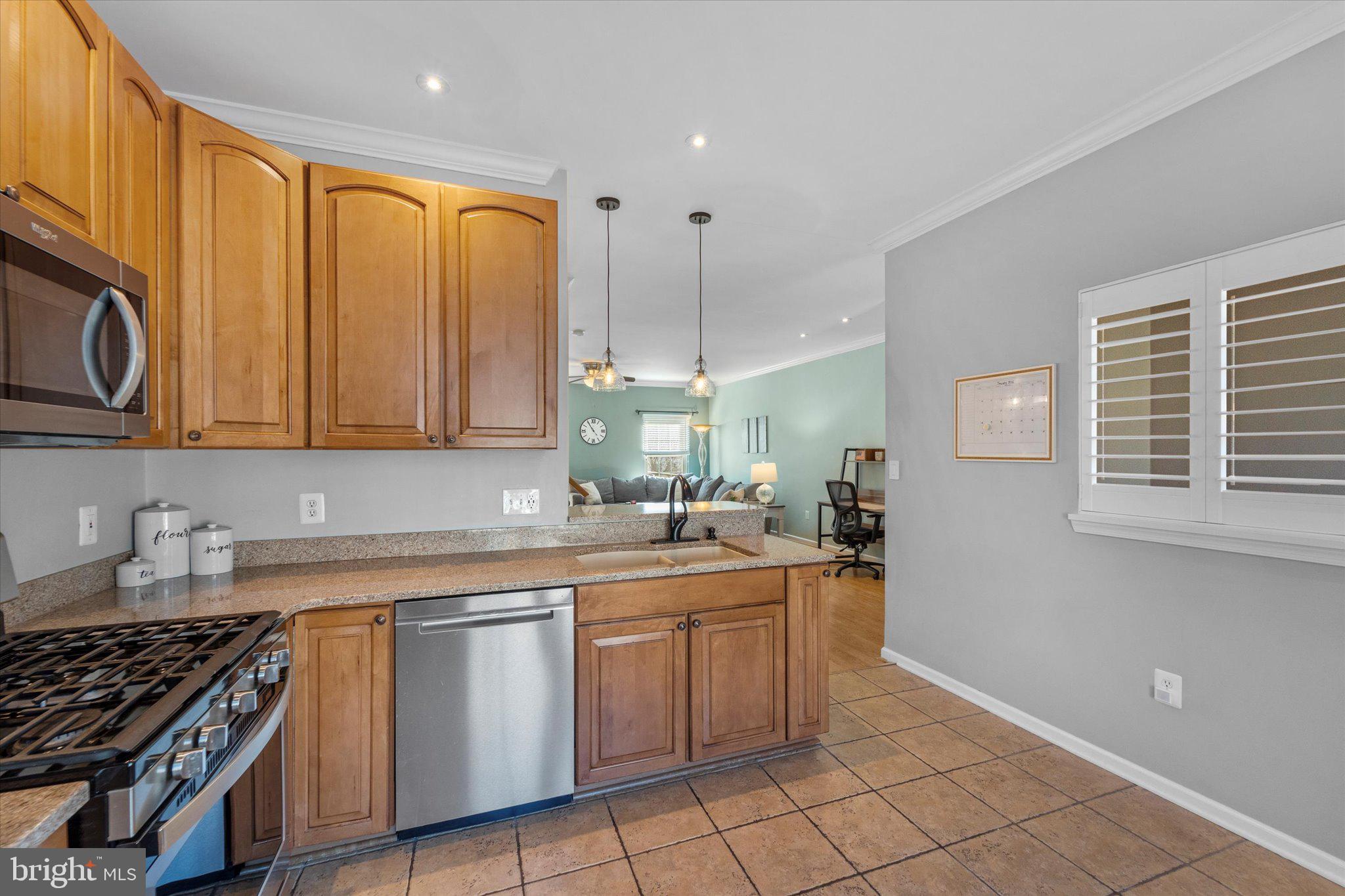 21070 Tyler Too Terrace Ashburn, VA 20147 - Photo 15 of 66 a kitchen with a sink and cabinets