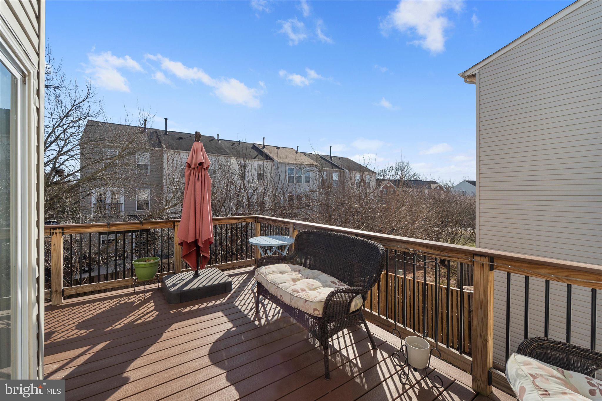 21070 Tyler Too Terrace Ashburn, VA 20147 - Photo 20 of 66 a view of a balcony with wooden floor and outdoor seating