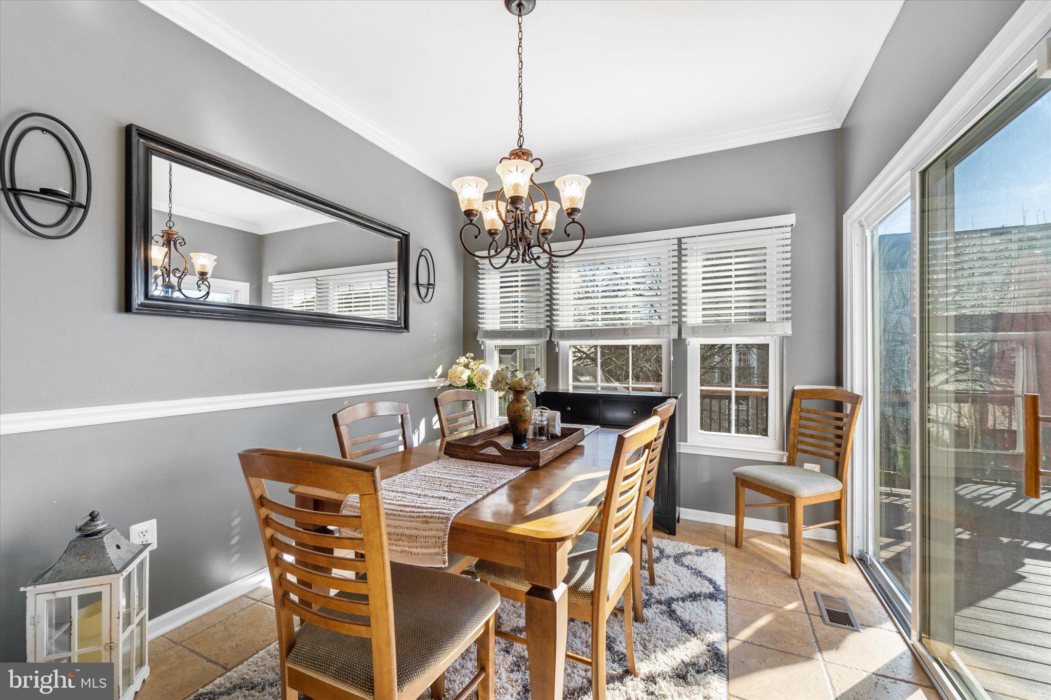 21070 Tyler Too Terrace Ashburn, VA 20147 - Photo 22 of 66 a view of a dining room with furniture a chandelier and wooden floor
