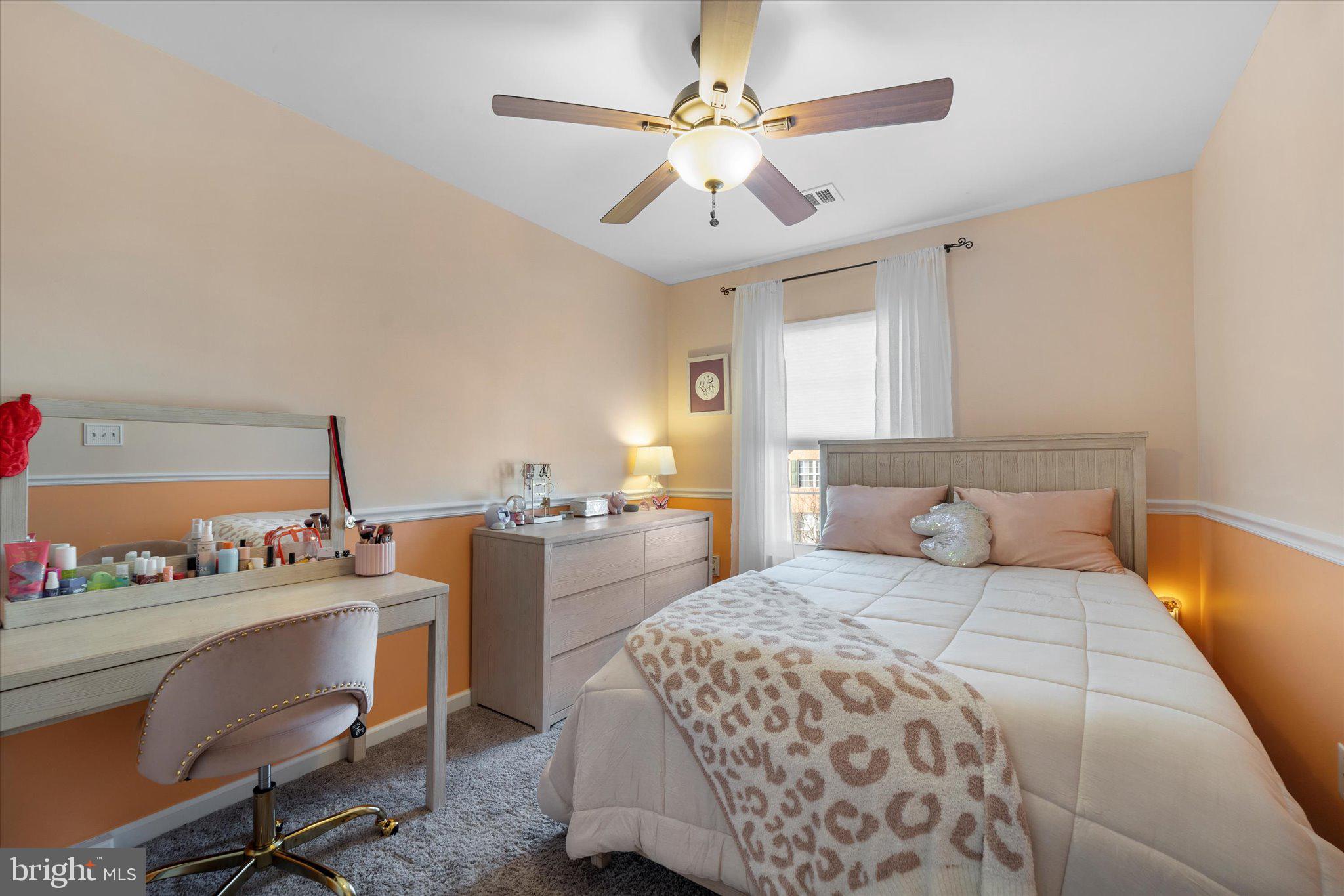 21070 Tyler Too Terrace Ashburn, VA 20147 - Photo 32 of 66 a bedroom with a bed table chair and window