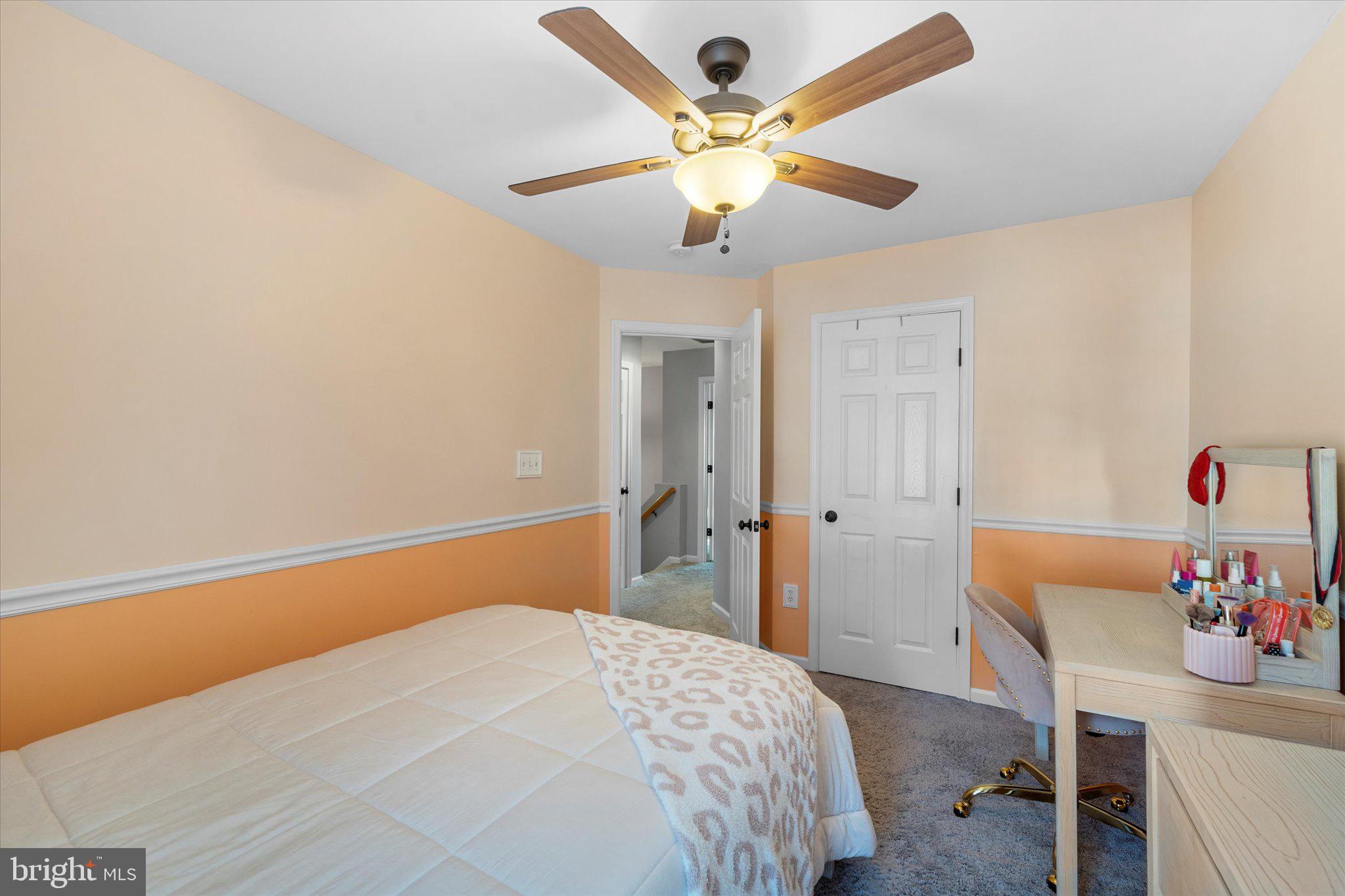 21070 Tyler Too Terrace Ashburn, VA 20147 - Photo 33 of 66 a bedroom with a bed and a chandelier