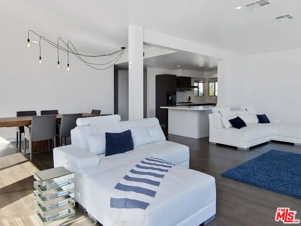 a living room with furniture and kitchen view