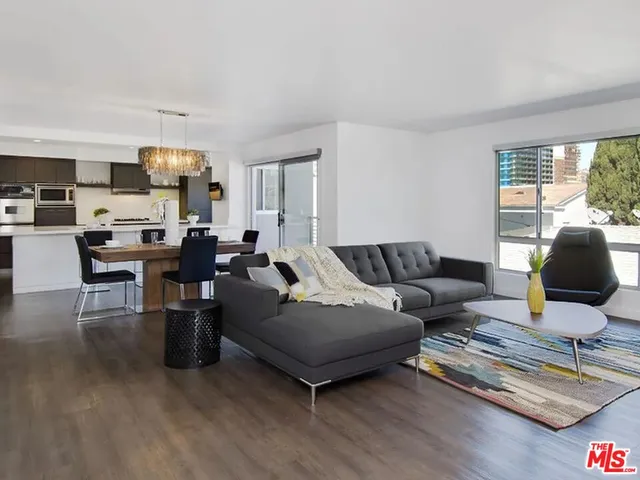 a living room with furniture rug and window