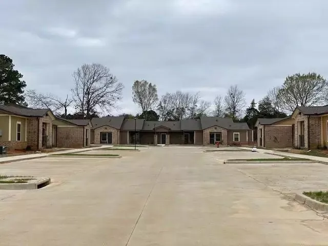 front view of a house with a yard and trees