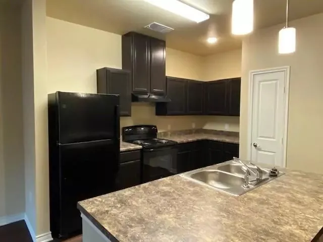 a kitchen with a refrigerator and a sink