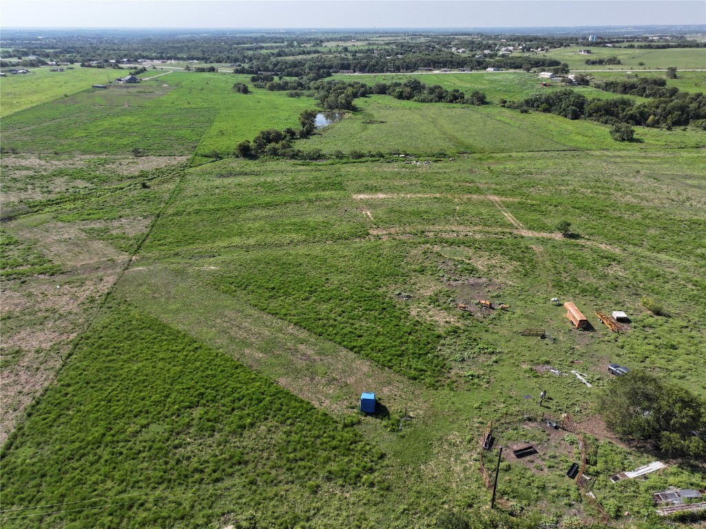 a view of a green field with lots of trees