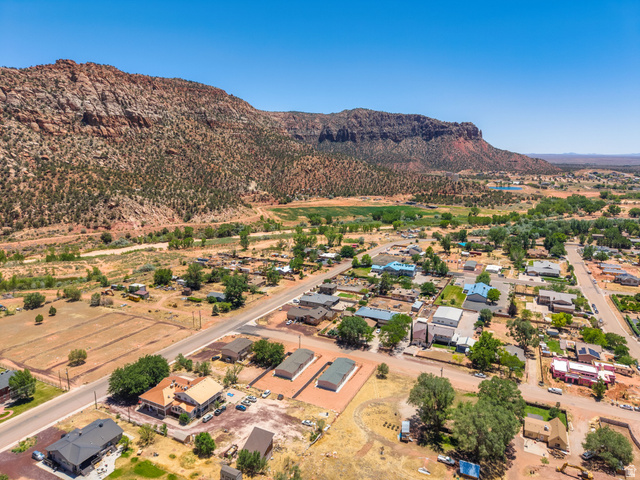 464 Jessop Avenue Hildale, UT 84784 - Photo 61 of 73 Expansive aerial perspective showcasing a townscape nestled against a large, rugged mountain range