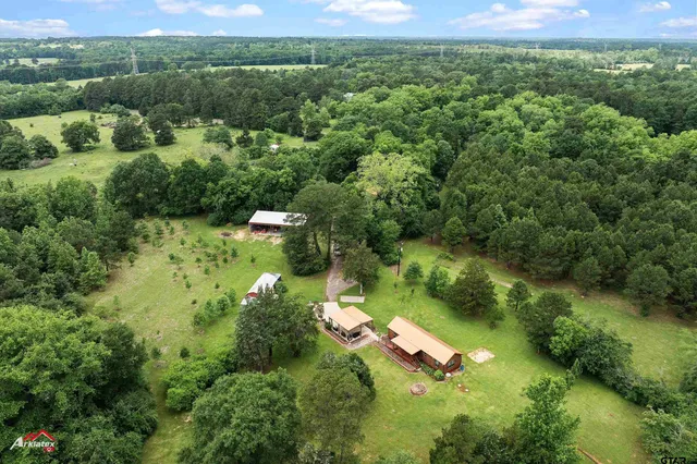 an aerial view of a house with a yard